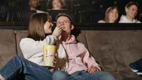 Una pareja come palomitas en el cine mientras ve uno de los últimos estrenos de la cartelera / PEXELS