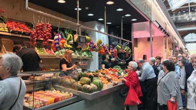 Clientes en un puesto de frutas y verduras en el Mercat de Sant Antoni / CG