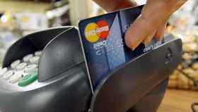 Un comerciante cobrando con una tarjeta de crédito / EFE
