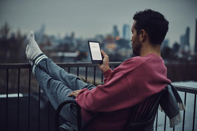 Hombre leyendo un libro electrónico / KINDLE