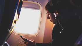 Pasajero utilizando su móvil durante un viaje en avión / UNSPLASH