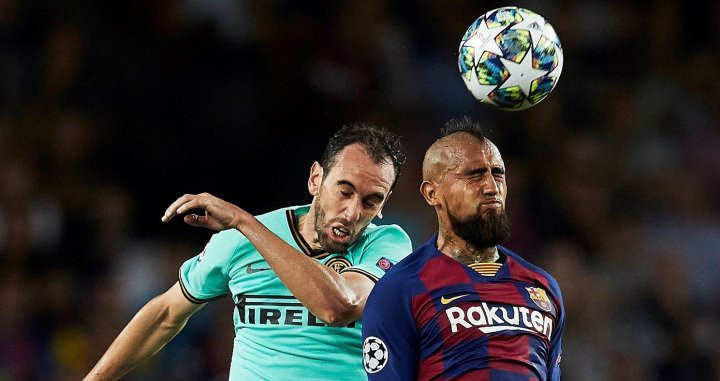 Arturo Vidal pelea un balón con Godín / EFE