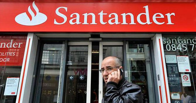 Un hombre pasa por delante de una oficina de Banco Santander, en una imagen de archivo / EFE