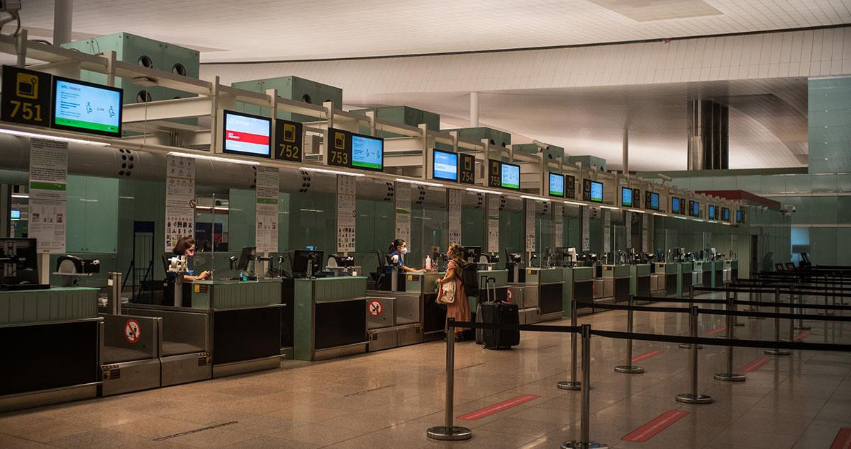 Una pasajera factura su equipaje en el Aeropuerto del Prat / EUROPA PRESS