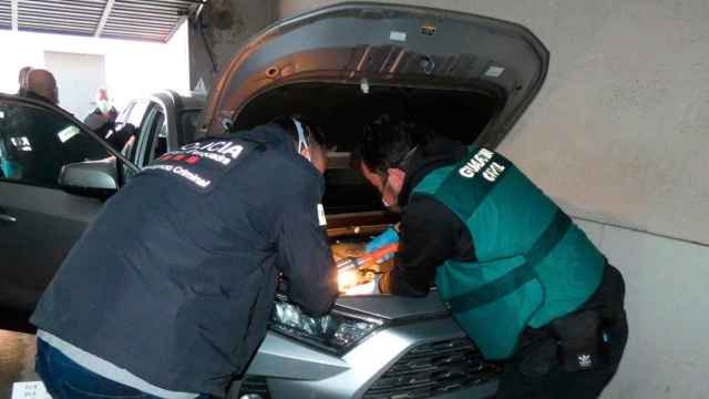 Dos agentes inspeccionan un coche intervenido durante una operación contra un grupo criminal dedicado al robo de vehículos / MOSSOS