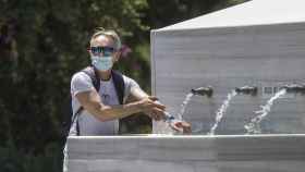 Un ciudadano se refresca en una fuente ante la ola de calor que afecta a varios territorios / EP