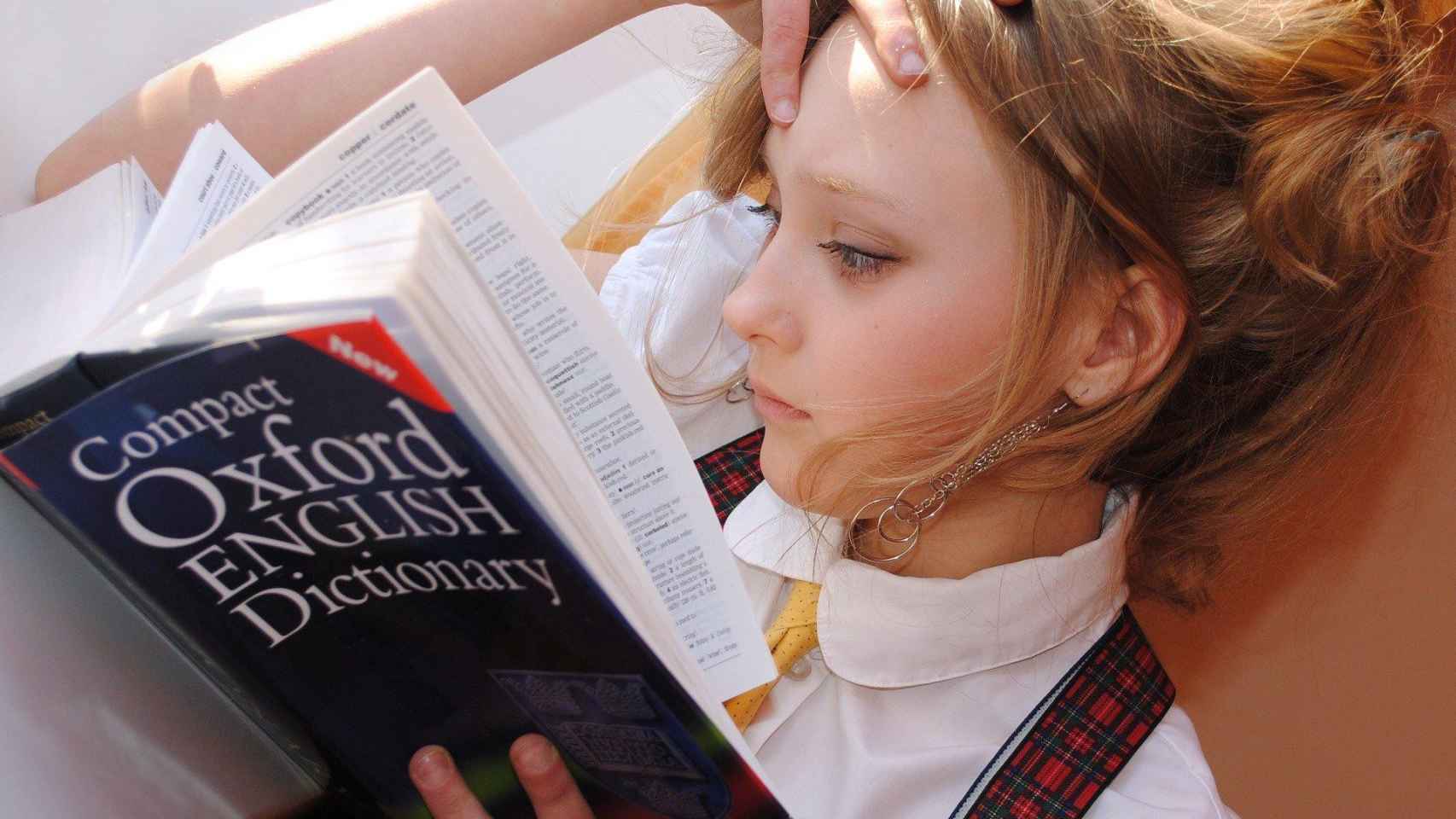 Una chica estudia inglés concentrada