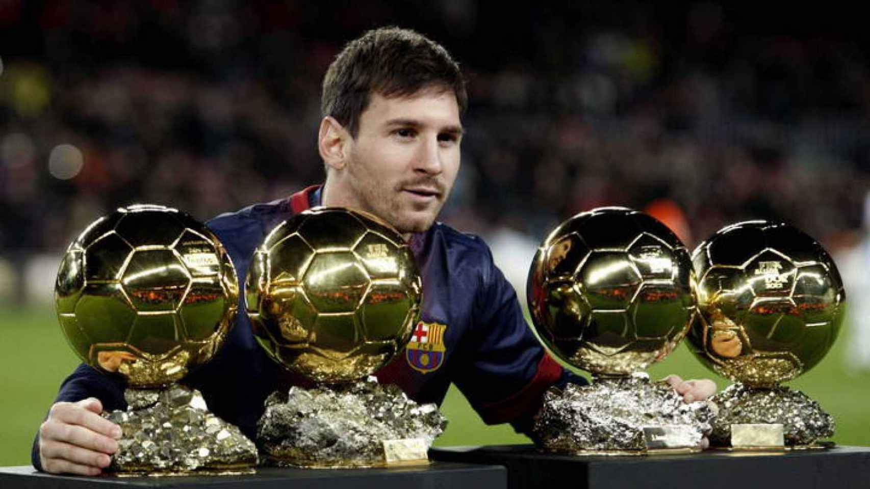 Leo Messi con sus primeros cuatro Balones de Oro / EFE