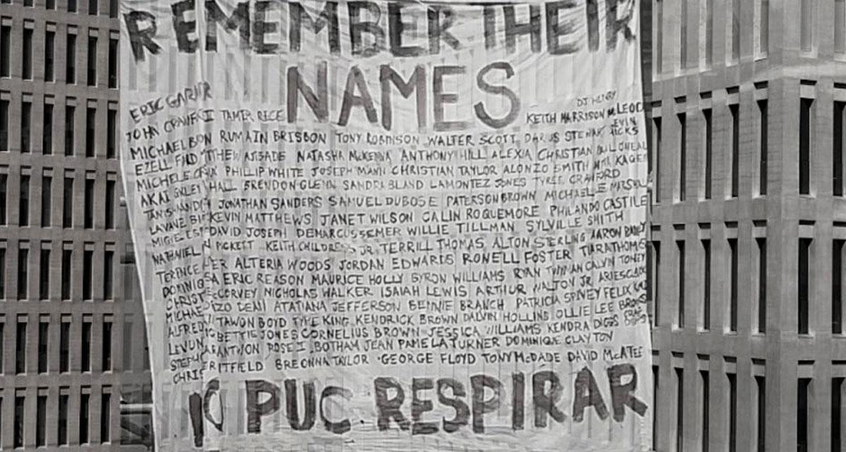 Pancarta con los nombres de las víctimas de racismo policial en la Ciutat de la Justicia / SOS RACISME