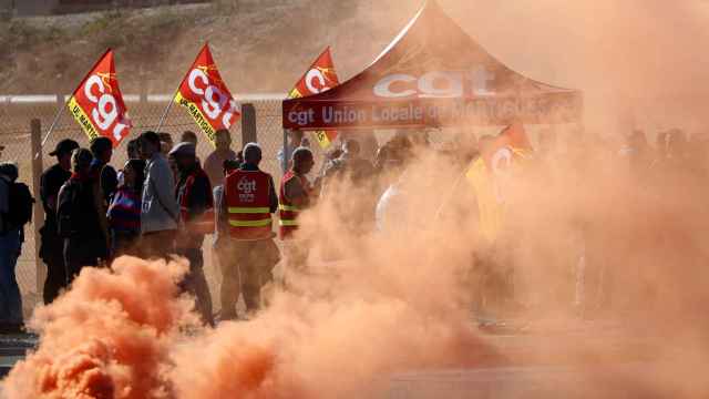 Trabajadores de TotalEnergies y Esso ExxonMobil lanzan bombas de humo de colores durante una protesta convocada por el sindicato CGT ante la refinería de TotalEnergies en Francia / EFE