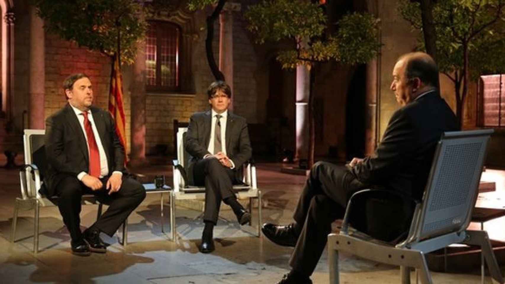 Imagen de archivo de una entrevista del director de TV3, Vicent Sanchis, al entonces presidente de la Generalitat, Carles Puigdemont (d) y al que era vicepresidente, Oriol Junqueras / CG