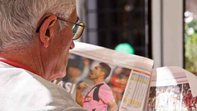 Un pensionista lee un diario deportivo