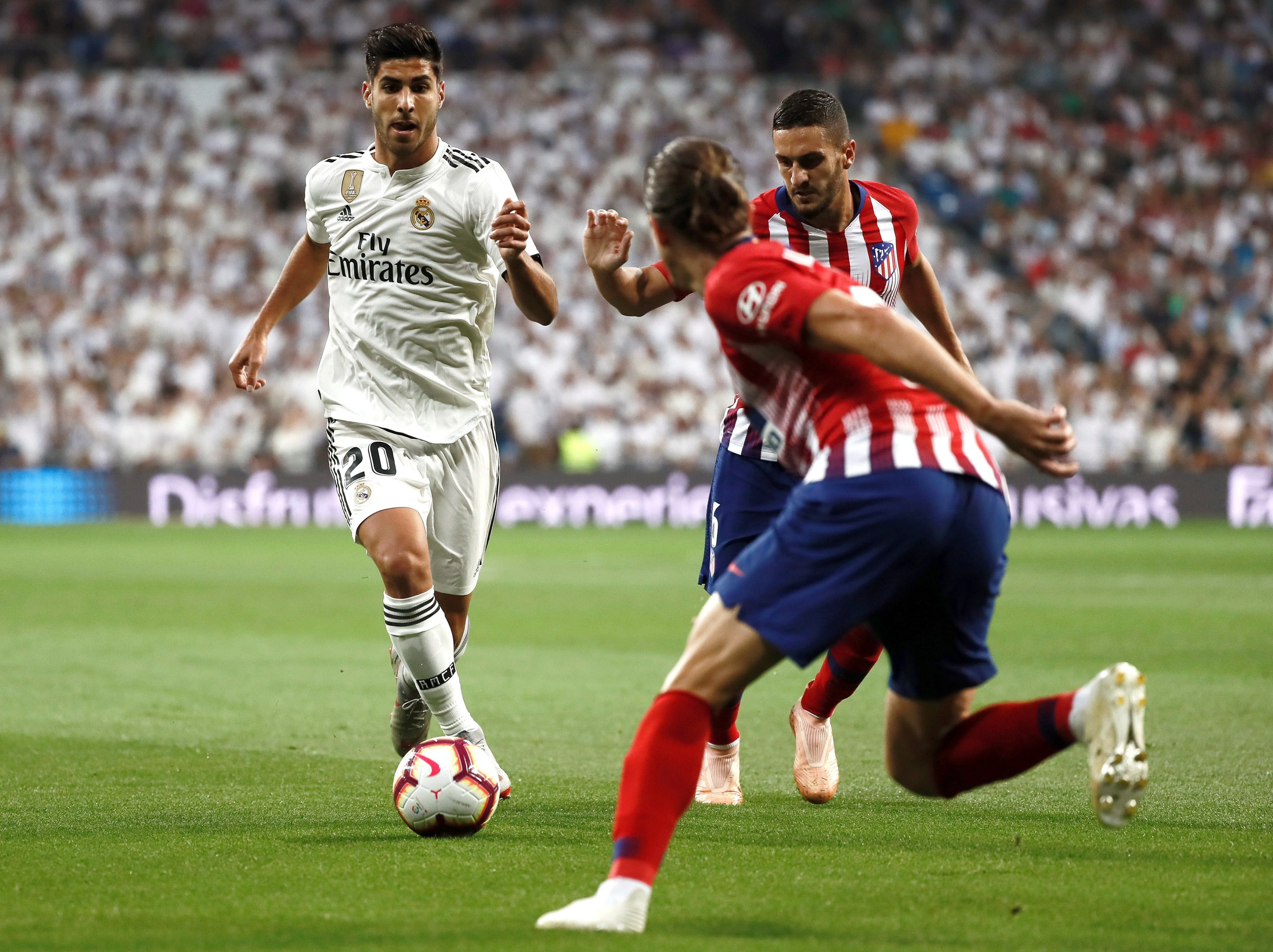 Marco Asensio conduce el balón durante el Real Madrid-Atlético / EFE