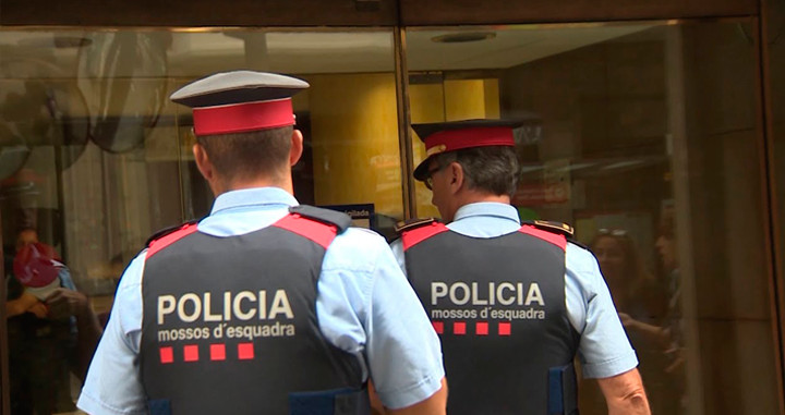 Imagen de dos agentes de los Mossos d'Esquadra entrando en un edificio público / CG