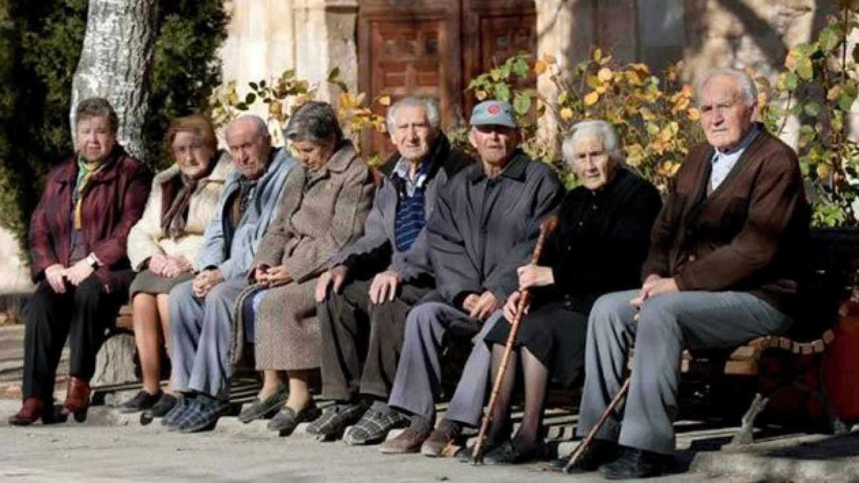 Imagen de archivo de un grupo de ancianos sentados en un banco