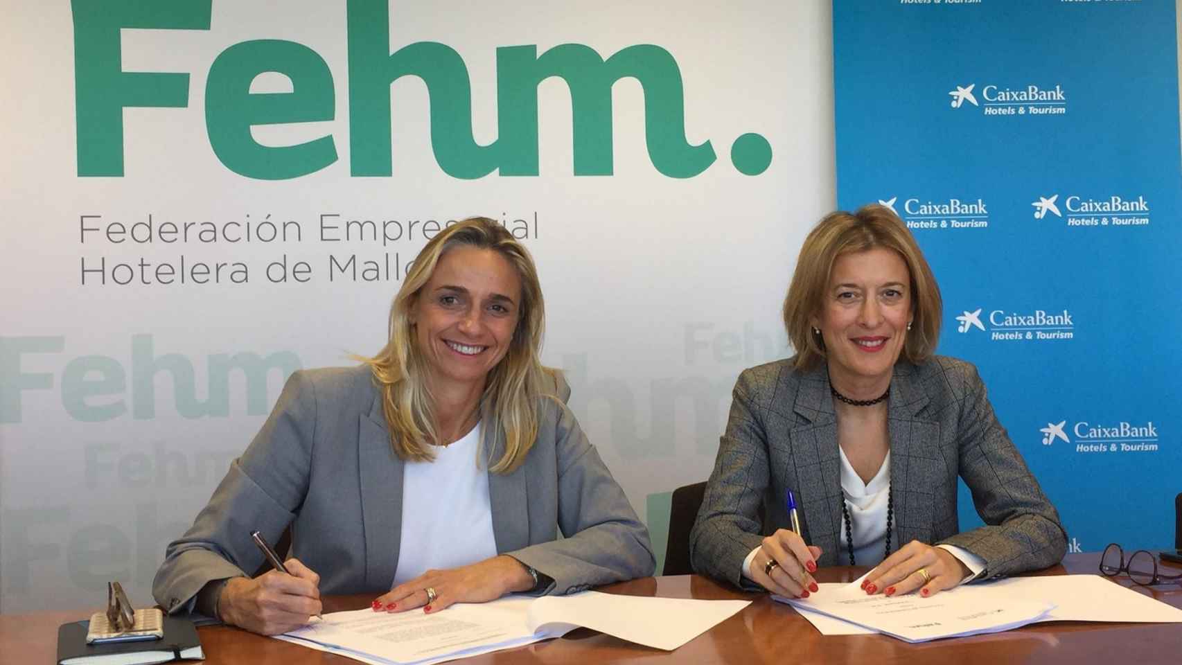 María Frontera, presidenta de la FEHM, y María Cruz Rivera, directora territorial de CaixaBank en Baleares, en la firma de una línea de financiación de 700 millones