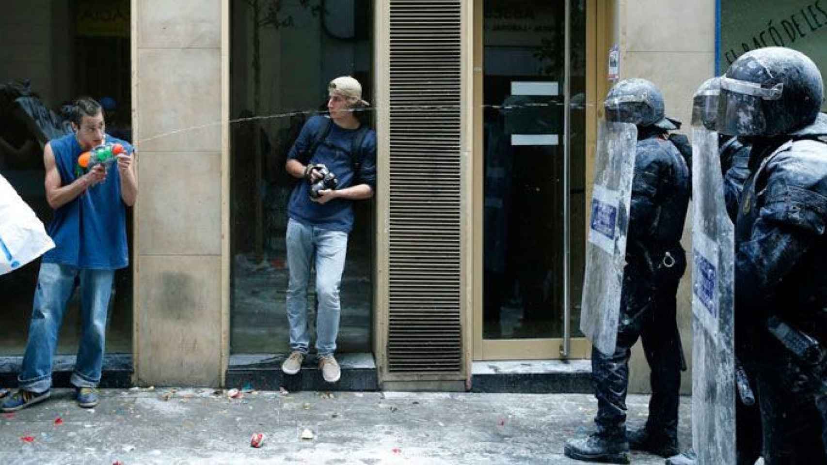 Un okupa dispara con una pistola de agua a varios agentes de los Mossos d'Esquadra en Barcelona, ciudad gobernada por Colau, quien bloquea la oficina antiokupas / EFE