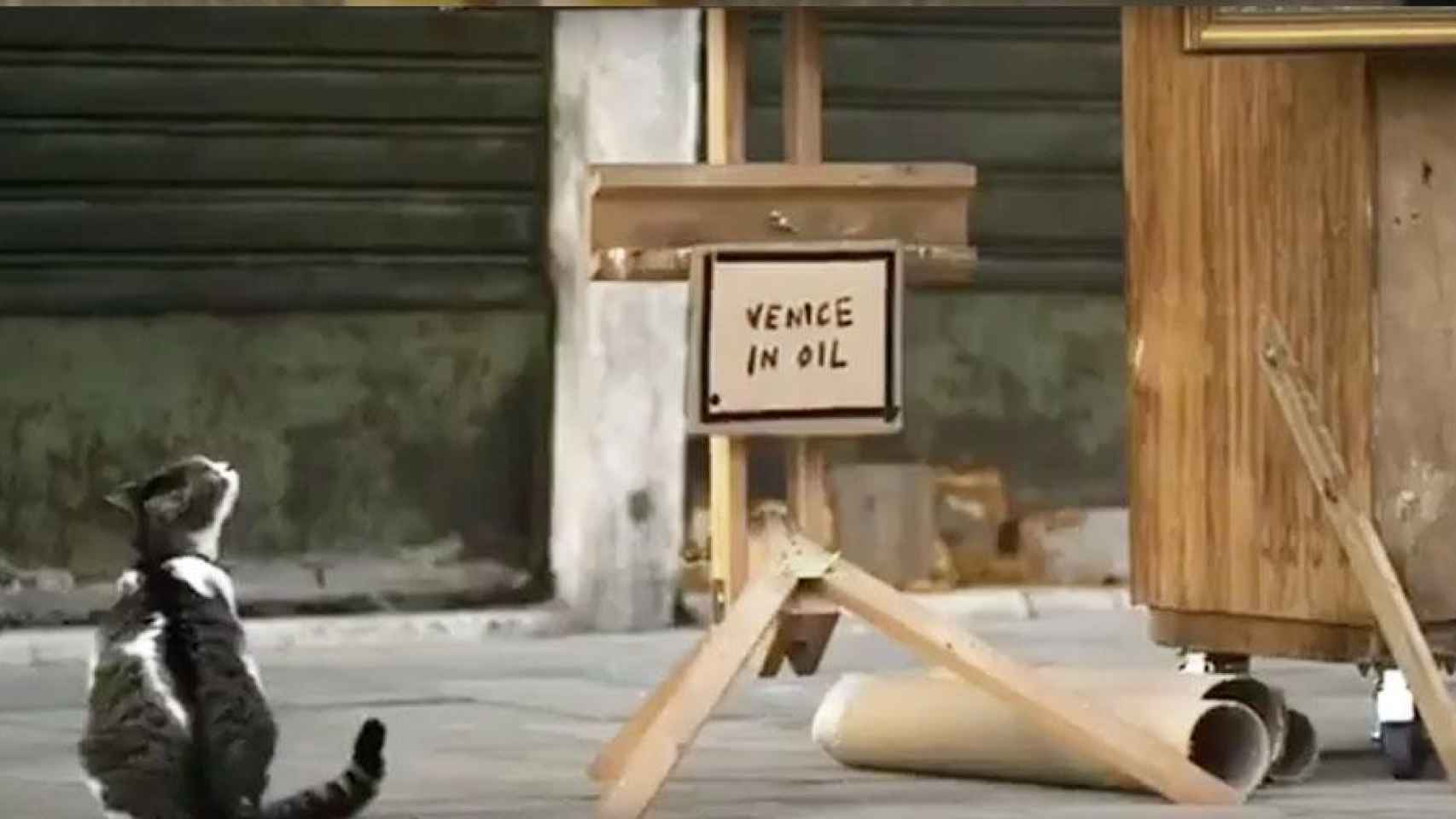 Un gato junto al título de la nueva obra de Banksy