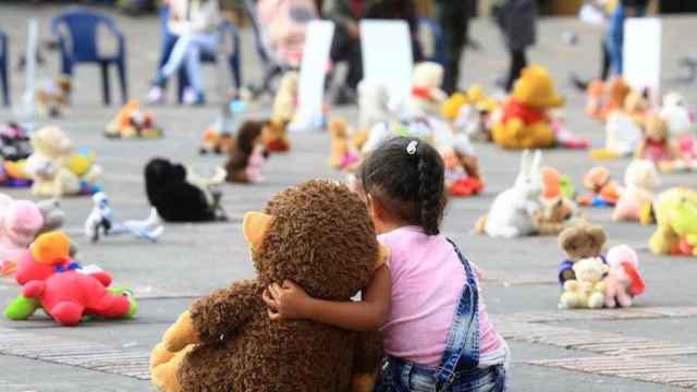 Niña abrazando a un oso de peluche, imagen que ilustra la historia de Eugenio y Trapitos / EFE