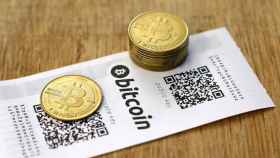Monedas bitcoin, las criptomonedas más famosa, sobre una mesa / EFE