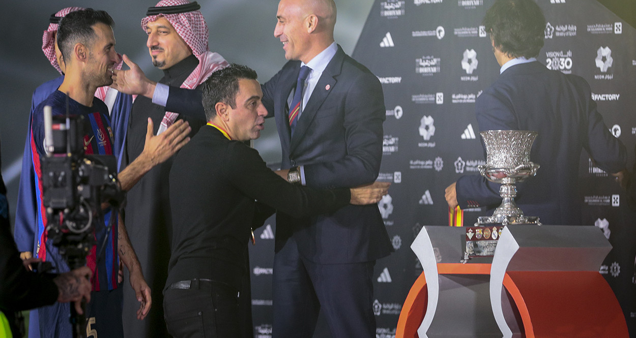 Xavi, delante de Busquets, saluda a Luis Rubiales, después de conquistar la Supercopa de España / EFE