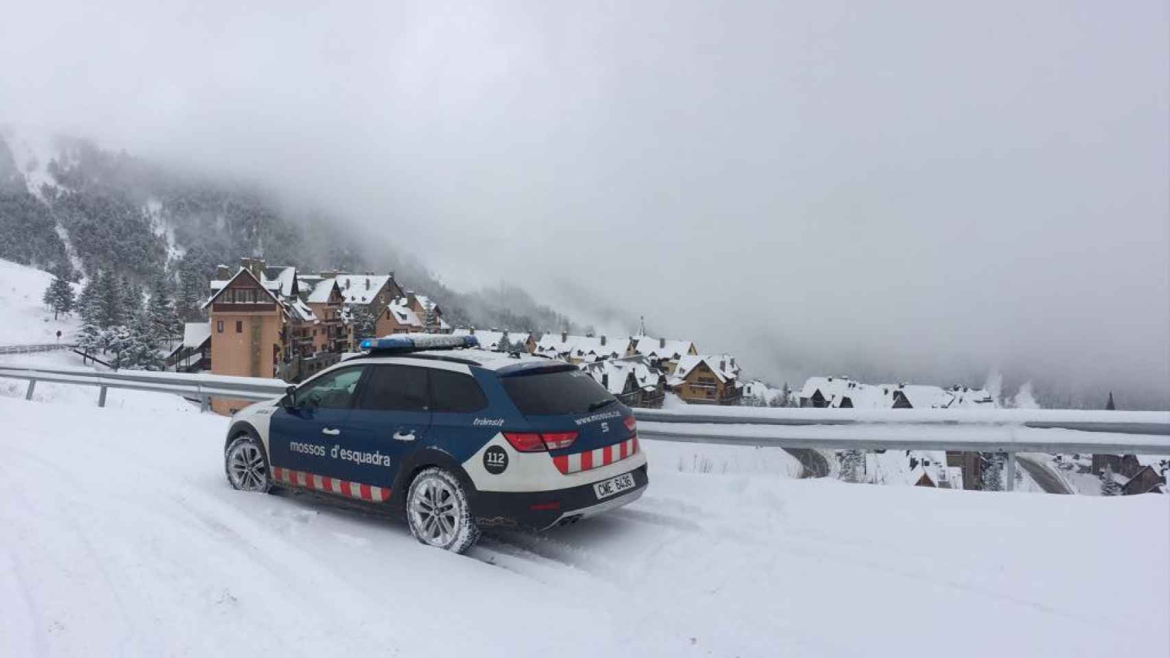 Imagen de un coche patrulla de los Mossos d'Esquadra en una zona montañosa de Cataluña llena de nieve / Mossos