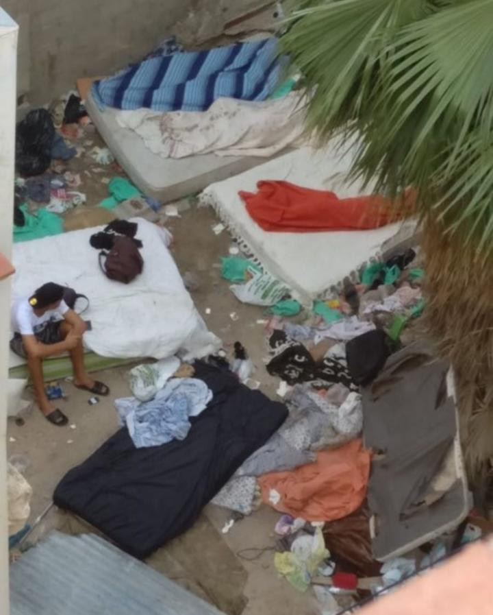 Un joven observa a sus compañeros dormir en el sucio solar donde viven en Barcelona / CG