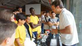 El CEO de Casual Robots, Pablo Medrano, explica a un grupo de niños conocimientos de programación para robots.