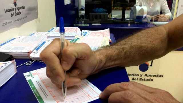 Un hombre rellena un boleto de la Primitiva en una administración de loterías / EP