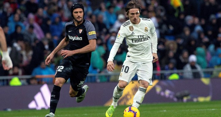 Modric (Real Madrid) disputando el balón con Vázquez del Sevilla / EFE