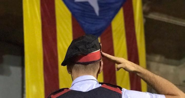 Imagen de un 'mosso' saludando la estelada, una bandera no oficial en Cataluña / TWITTER