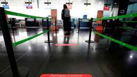 Un pasajero, en un aeropuerto de El Prat en mínimos por la pandemia del coronavirus / EFE