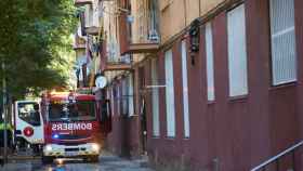 Los bomberos, en el lugar del incendio que ha costado la vida a dos hermanos en Barcelona.