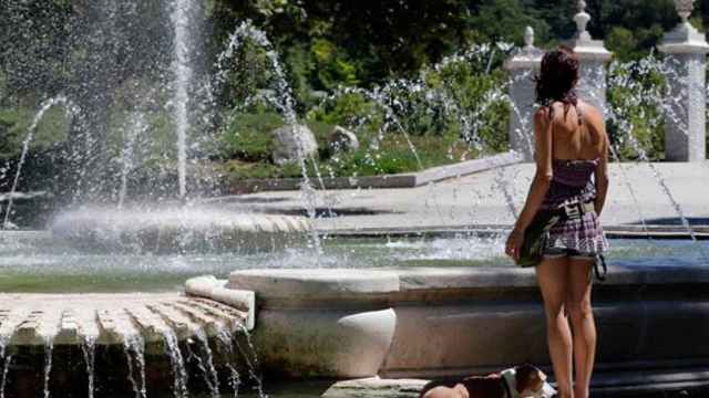 Una mujer se refresca en una fuente de Barcelona en una jornada de intenso calor / CG