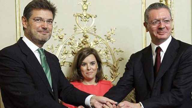 Rafael Catalá y Alberto Ruiz-Gallardón, los dos ministros de Justicia que ha tenido Rajoy, el día de la salida del segundo. En el centro, la vicepresidenta Soraya Sáenz de Santamaría.