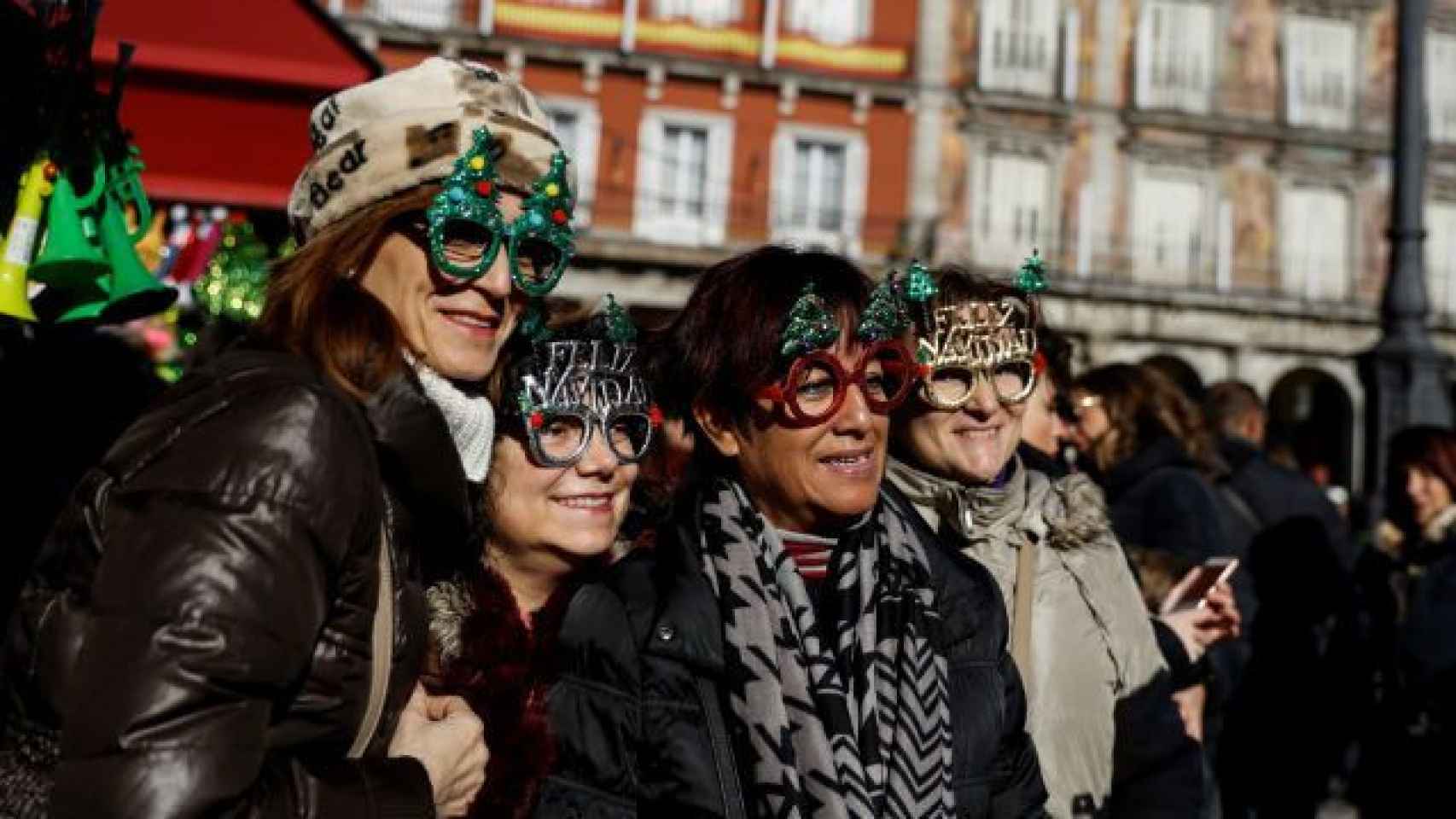 Cuatro turistas con máscaras se hacen una foto en la Plaza Mayor de Madrid ⁄ EFE