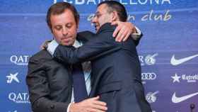 El ex presidente del F.C. Barcelona Sandro Rosell, tras dimitir de su cargo, recibe el abrazo de su sucesor, Josep Maria Bartomeu.