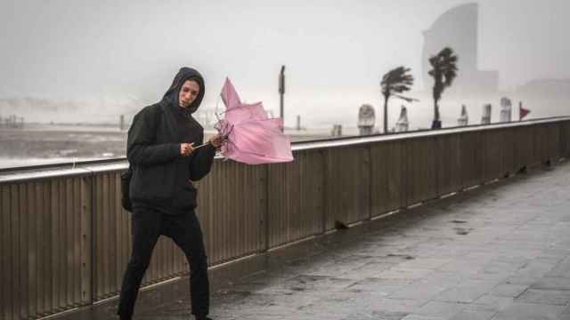 Un joven sujeta un paraguas bajo las fuertes lluvias de la borrasca 'Gloria' en Cataluña / EUROPA PRESS
