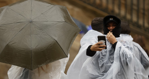 Los turistas y peregrinos bajo la lluvia esta mañana de martes en la plaza del Obraodiro, Galicia / EFE