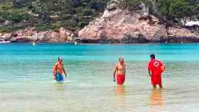 Un socorrista llama la atención a Artur Mas (con bañador azul) por bañarse con bandera roja / EP