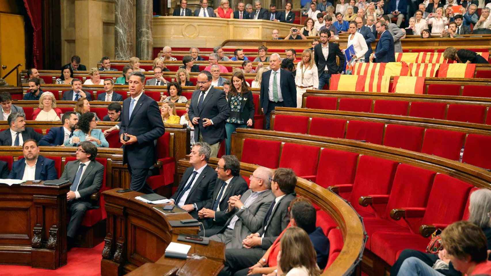 Los diputados del PP y de Ciudadanos abandonaron el Parlament en las tormentosas sesiones de los días 6 y 7 de septiembre dejando banderas españolas y catalanas en sus escaños / EFE