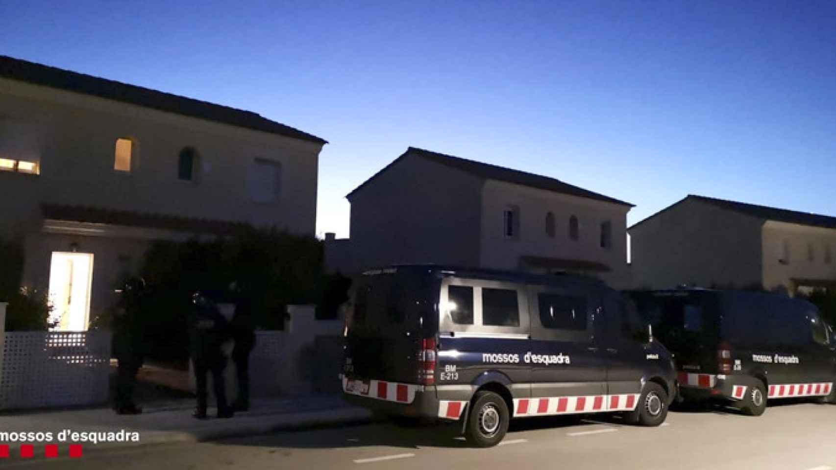 Varias furgonetas de los Mossos d'Esquadra ante una de las viviendas registradas en la operación contra los robos de la AP-7 / MOSSOS