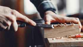 Un carpintero trabajando la madera en su taller / FREEPIK