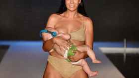 La modelo Mara Martin mientras desfila con su bebé