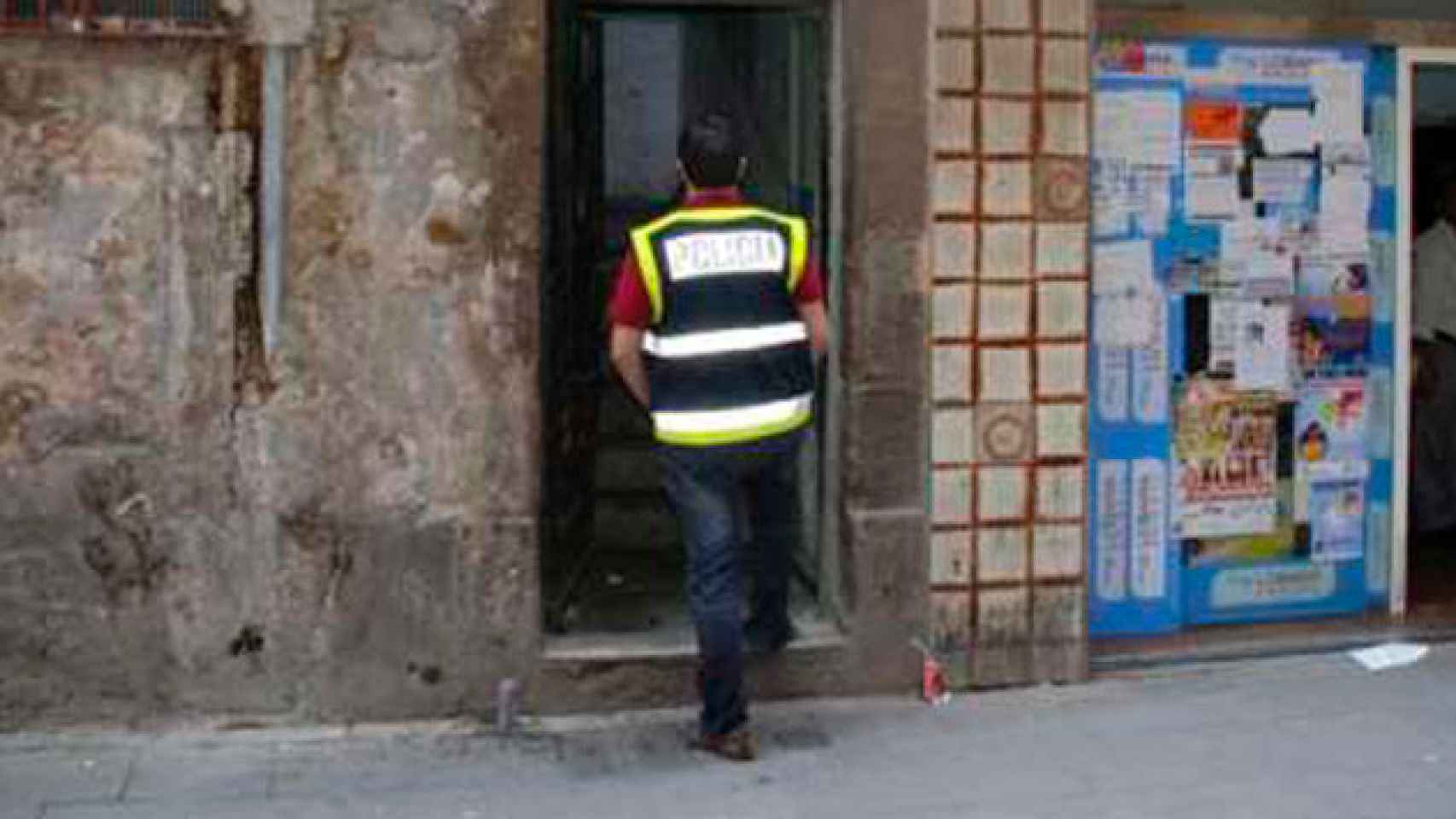 Un agente de la Guardia Urbana entra en un piso del barrio el Raval, imagen de archivo / CG
