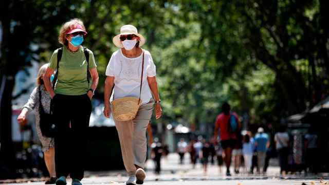 Dos mujeres sin distancia de seguridad pero protegidas con mascarillas / EFE