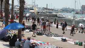 Un grupo de 'manteros' venden en el puerto de Barcelona. / EFE