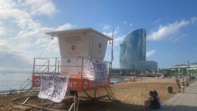 Un punto de vigilancia de los socorristas de Barcelona en la playa de la Barceloneta con pancartas de huelga