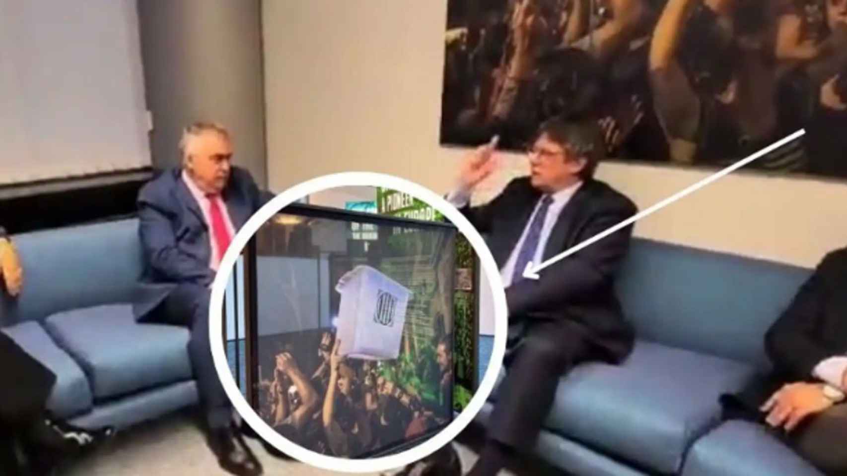Santos Cerdán y Puigdemont se reúnen en una sala con una foto de una urna del 1-O, retirada por el Parlamento europeo