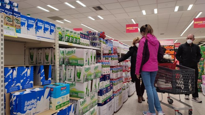 Varias personas compran leche en un supermercado. / EFE